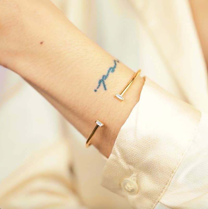 OPEN GOLD CUFF WITH CLEAR RECTANGLE STONE